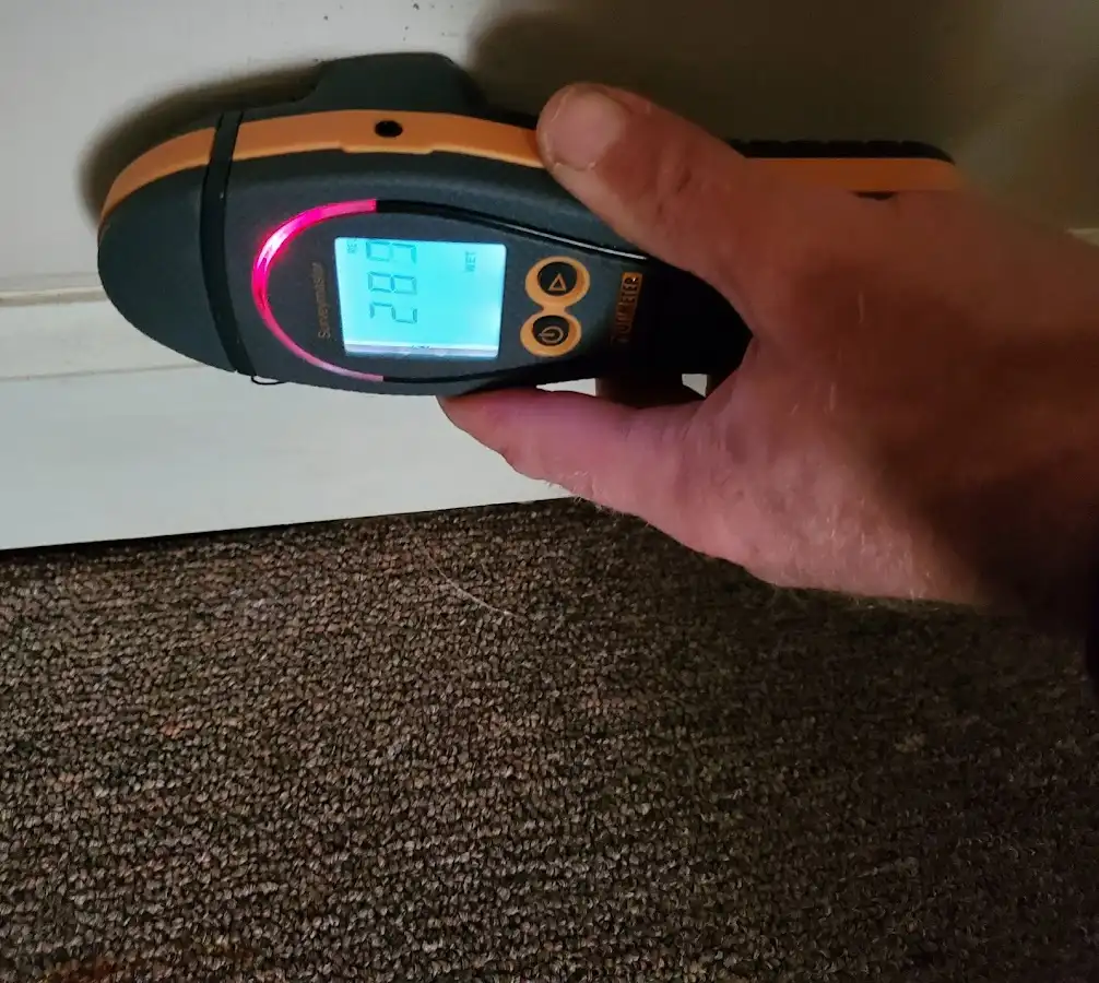 Moisture detection at baseboard during Storm Damage Restoration in Danville
